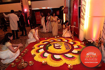 Setting oil lamps in place around the Kolam